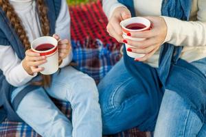 Hands woman and child holding cup tea photo