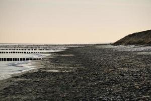 on the beach of the baltic sea with clouds, dunes and beach. Hiking in spring. photo