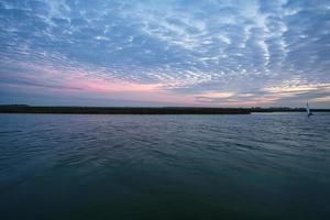 from the harbor in zingst the bodden view with burning sky photo