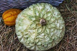 decorated pumpkin. carvings in a decorative pumpkin. Harvest festival. Craftsmanship photo