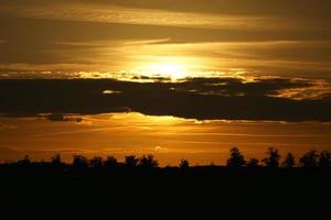 Setting sun on the outskirts of Berlin. The sky seems to burn. photo