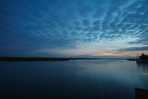 from the harbor in zingst the bodden view with burning sky photo