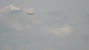 Front view of airplane flying in haze approaching landing. Tourism and travel concept video