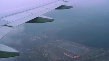 Aerial view from the aircraft flying over Moscow., view from the airliner porthole. video