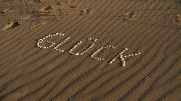 with shells laid symbol happiness on the beach of the Baltic Sea in the sand photo