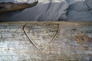 Heart carved into a tree trunk. Proof of love for lovers. photo