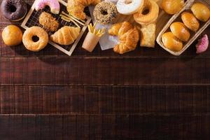 assorted junk food multiple type on wooden table of top view with copy space photo