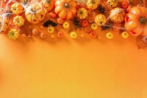 Halloween decoration on orange color background top view with copy space photo