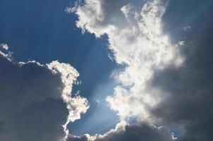 Clouds illuminated by the sun in the sky as background photo