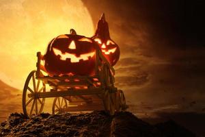 Halloween pumpkins on farm wagon at spooky in night of full moon photo