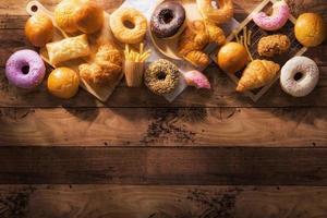 assorted junk food multiple type on wooden table of top view with copy space photo