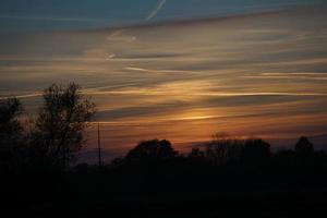 Setting sun on the outskirts of Berlin. The sky seems to burn photo