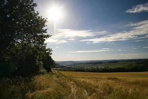 landscape with hills, fields, meadows, and agriculture. Hiking in nature. photo