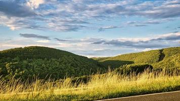 Sunset in Saarland on a meadow with trees and view into the valley. warm atmosphere photo