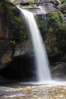 A natural waterfall in a big forest in the midst of beautiful nature. photo