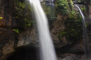 A natural waterfall in a big forest in the midst of beautiful nature. photo