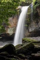 A natural waterfall in a big forest in the midst of beautiful nature. photo