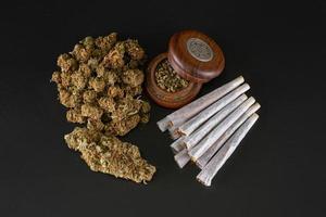 big bud and lots of small buds ready to roll with full ginder and rolled joints photo