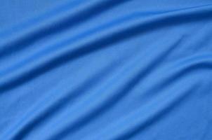 Detailed polyester blue fabric texture with many folds photo