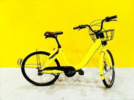 Yellow bicycle parking and isolated on yellow wall background photo