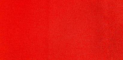 textura de la superficie del sofá rojo para fondo o papel tapiz. material suave y concepto de patrón foto