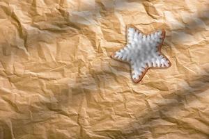 Close up of Christmas gingerbread cookie on brown paper background. photo