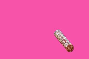 Piece of meat smoked bacon isolated on a pink background. photo