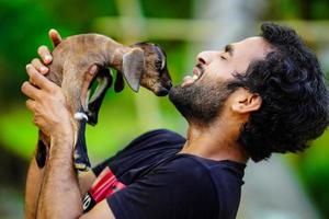 boy with cute baby goat pet animal photo