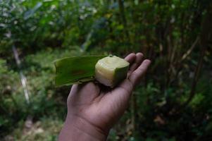 sweet snacks from sticky rice with durian topping that someone is holding. Indonesian traditional food. photo