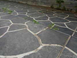 ceramic floor with river stone texture in black with white lines photo