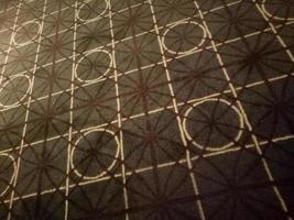 dark brown carpet with circle and square motif in the room photo