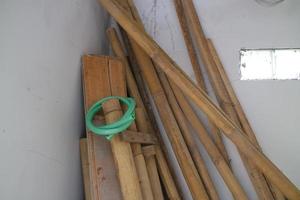 pile of used boards and bamboo in the corner of the room photo