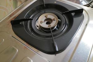 black square placemats on the gas stove photo