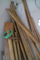 pile of used boards and bamboo in the corner of the room photo