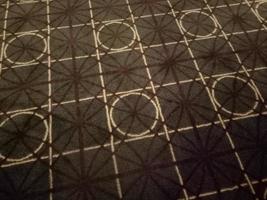 dark brown carpet with circle and square motif in the room photo