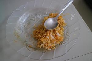 brown curly noodles on a clear glass plate photo