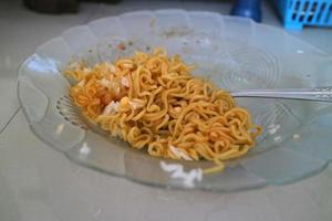 brown curly noodles on a clear glass plate photo