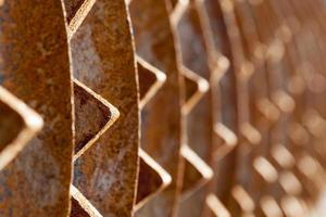 rusty metal element of the agricultural plow close up photo