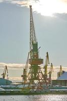 Harbor cranes, container ship terminal, cargo container yard photo