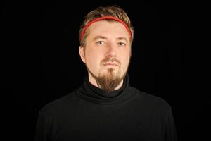 Funny bearded man with red headband, black background photo