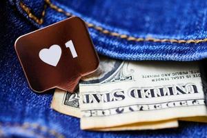 Like heart symbol and dollar in jeans pocket photo