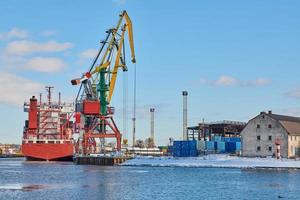 Moored ships and harbor cranes in port photo