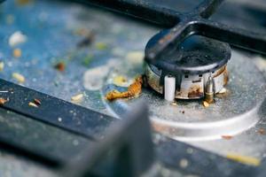 Dirty stove top with oil splatters, fat stains and food leftovers photo