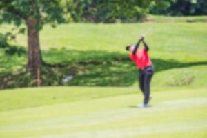 Man playing golf on golf course. photo