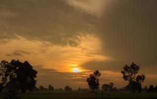 Stunning sunset views over meadows and orange sky above. photo