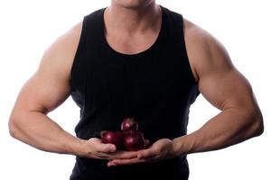 Raw food man holding vegetables and fruit photo