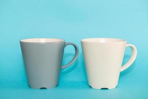 Coffee mugs on blue background photo