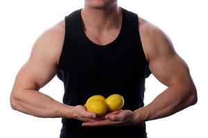 Raw food man holding vegetables and fruit photo