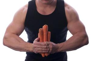 Raw food man holding vegetables and fruit photo