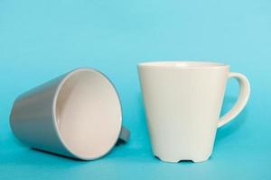 Coffee mugs on blue background photo